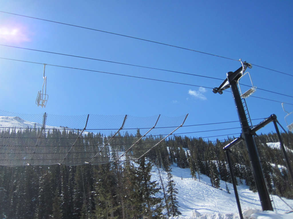 chairlift over loveland pass highway 6 with catch net below it to protect cars