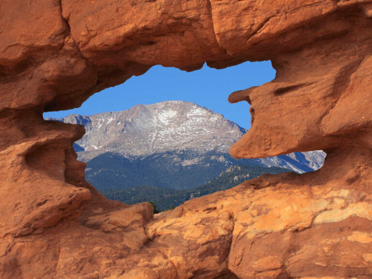 Pikes Peak seen through hole in the rocks at Garden of the Gods park in Colorado Springs