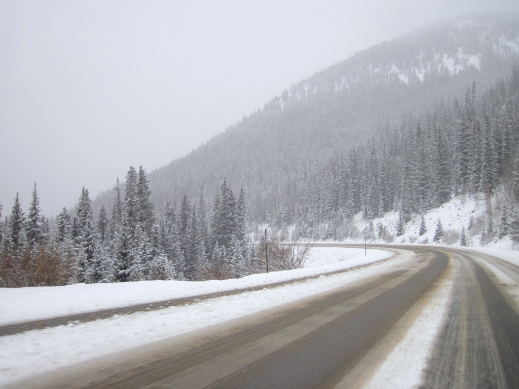 Highway 6 on Loveland Pass leading up to Arapahoe Basin in winter with road covered in snow