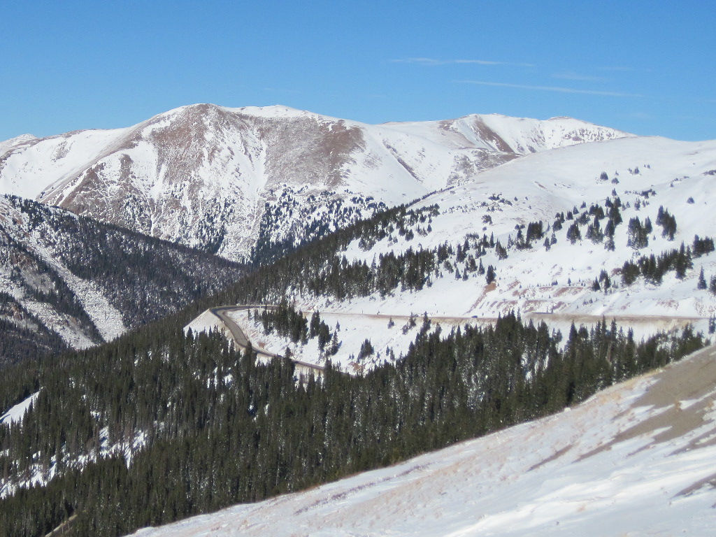 Loveland Pass on eastern side showing hairpin turn and winding Highway 6 from summit