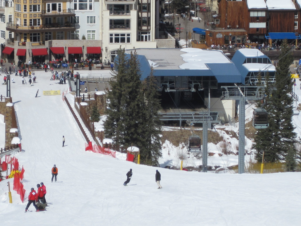 bottom of the Vail Eagle Bahn gondola with snow and skiers