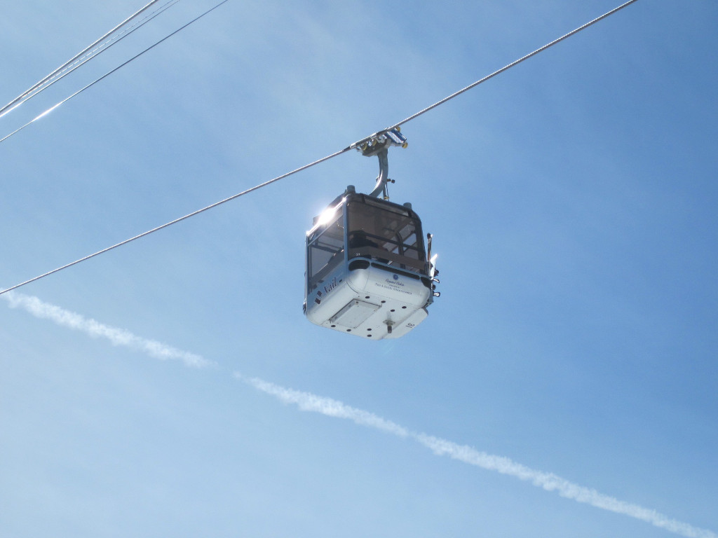 a gondola cabin on Vail's Eagle Bahn gondola seen from below with sun glistening