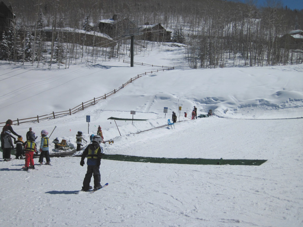 Children skiing at Telluride, CO on a carpet surface lift