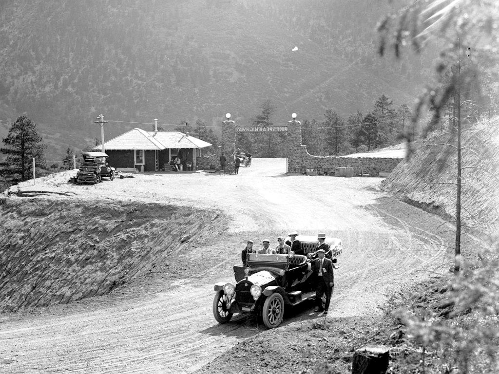 Pikes Peak Highway toll road entrance with toll house and press car