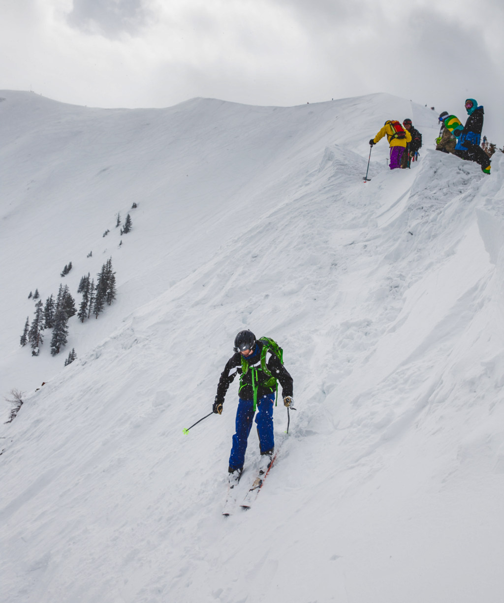 a skier drops into the Highland Bowl at Aspen Highlands on a powder day