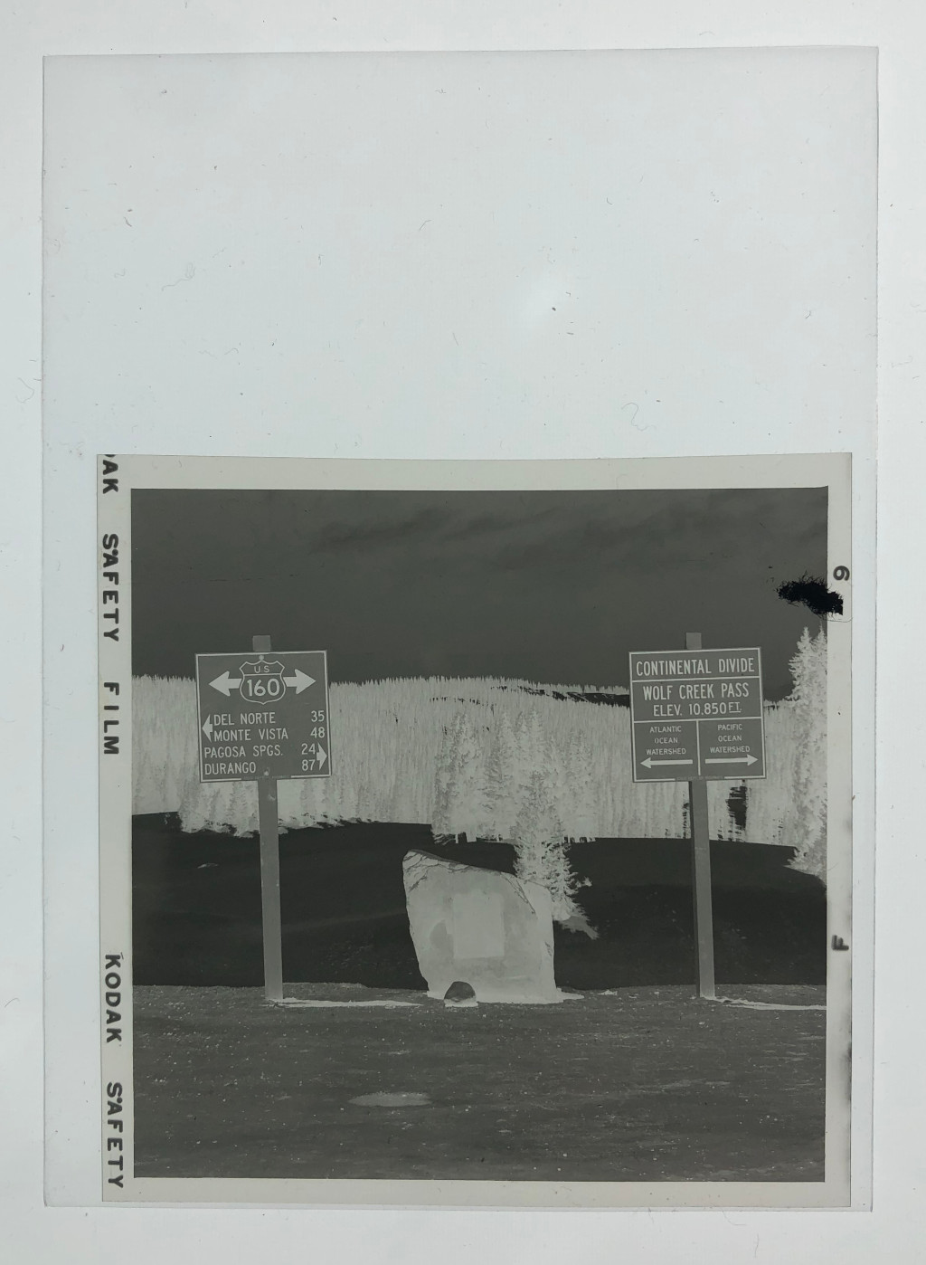 photo negative of wolf creek pass continental divide sign photo CWO-F9